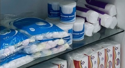 Cotton wool and first aid supplies on a pharmacy shelf.