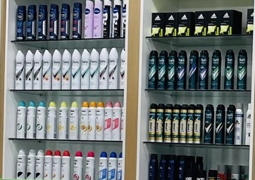 Deodorants and personal care bottles on the pharmacy shelves.